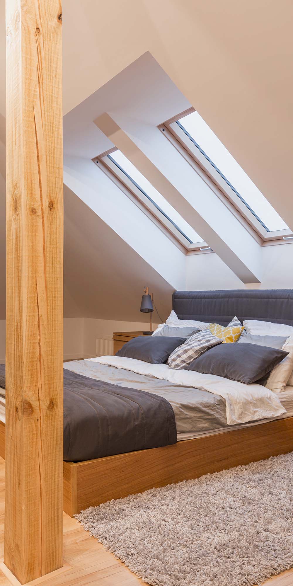 Attic bedroom with double bed and two skylight windows